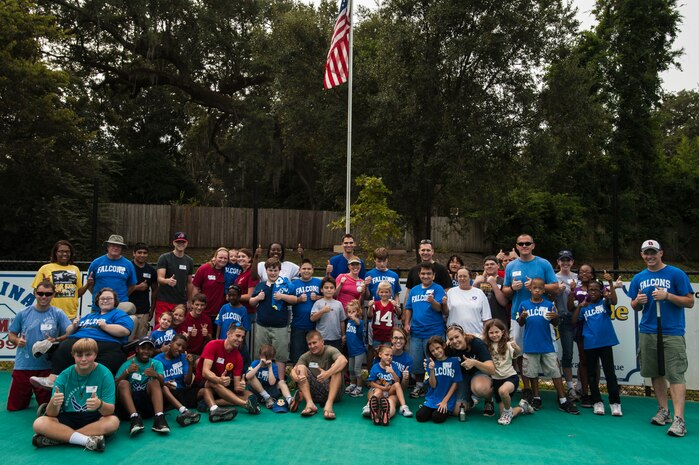 Airmen from the 437th Airlift Wing and members of the Falcons baseball team pose for a group photo Sept. 29, 2012, in Summerville, S.C. The goal of the Summerville Miracle League is to enhance the lives of people with special needs through the national pastime of baseball, bringing together athletes and their families in a positive and enriching way. (U.S. Air Force photo/ Airman 1st Class Chacarra Walker)