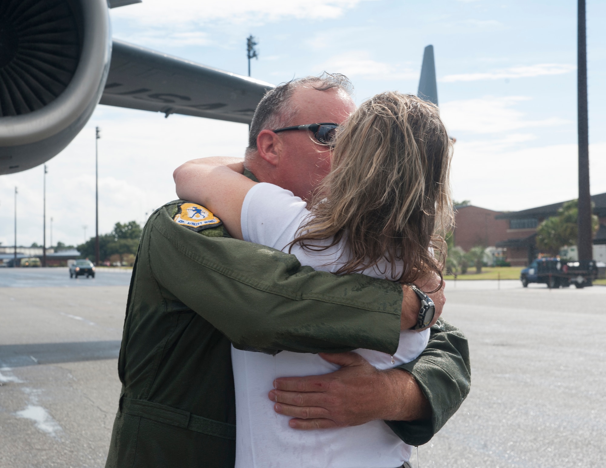 Col. Erik Hansen is greeted by his wife Susan after completion of his final flight as the 437th Airlift Wing commander at Joint Base Charleston - Air Base, S.C., Oct. 2, 2012. The final or "fini flight," is an aviation tradition in which aircrew members are met by their unit comrades, family and friends and soaked with water. (U.S. Air Force photo/ Airman 1st Class Ashlee Galloway) 
 
