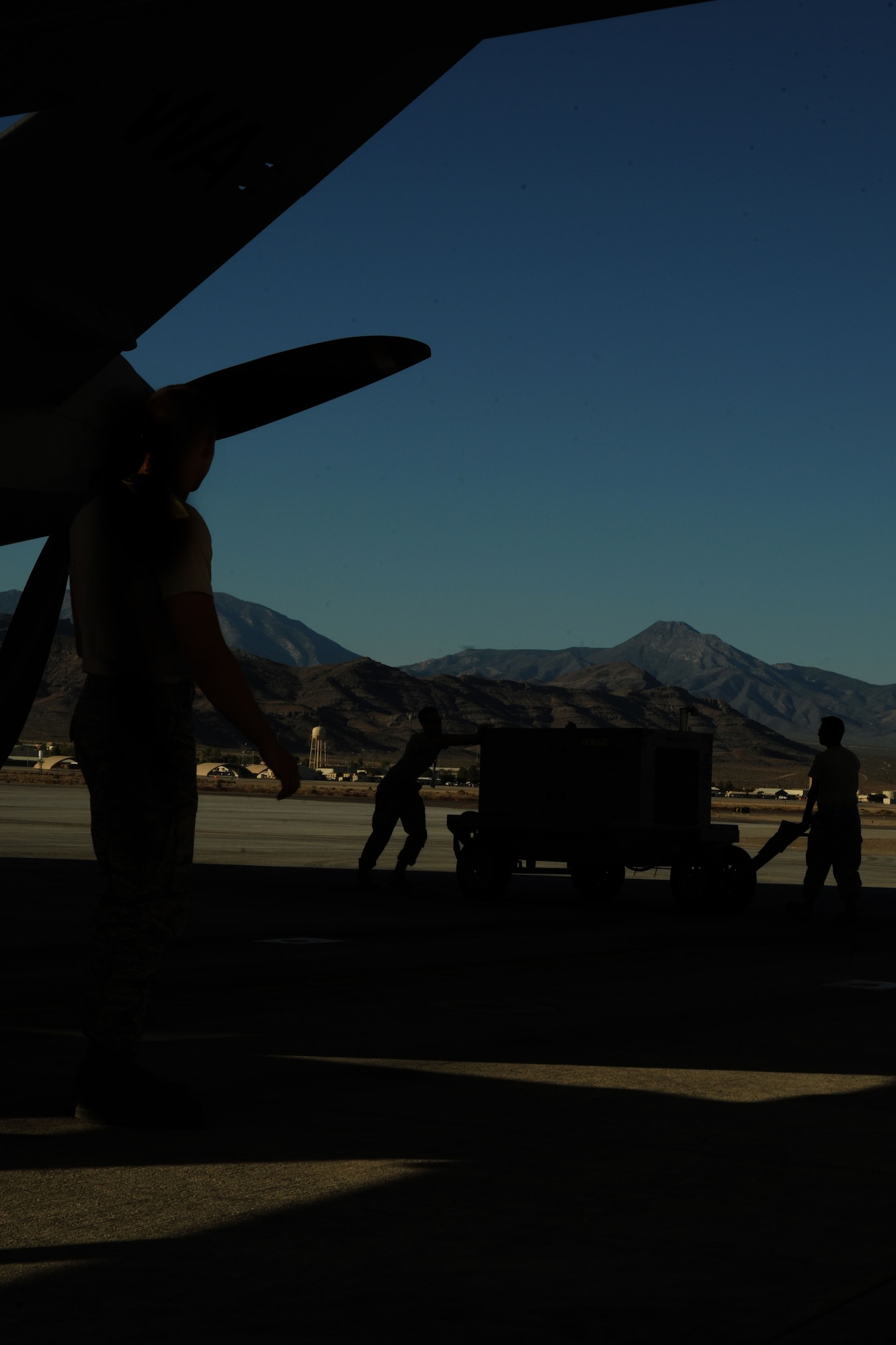 Airmen with the 432d Wing/432d Air Expeditionary Wing move equipment used to perform maintenance on an MQ-9 Reaper remotely piloted aircraft (RPA) during a pre-flight inspection. The MQ-9 is designed to pursue time sensitive targets with persistence and precision. (U.S. Air Force photo by 432d Wing/432d Air Expeditionary Wing Public Affairs)