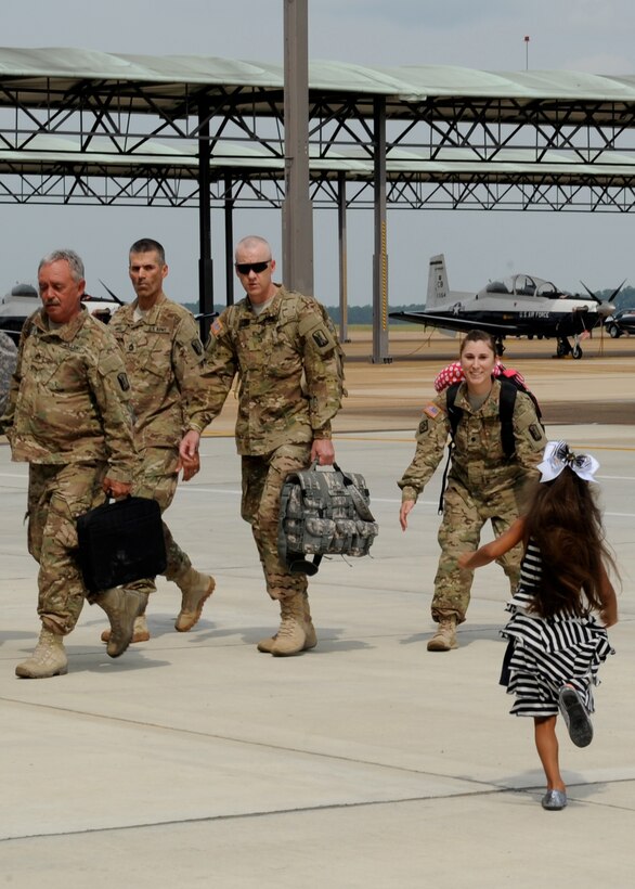 Spc. Megan Gandy, 223rd Engineer Battalion is welcomed home by her daughter before a ceremony at Columbus Air Force Base on Sept. 29.  The soldiers were met by families before returning to West Point and Aberdeen, Miss.  (U.S. Air Force Photo/Elizabeth Owens)