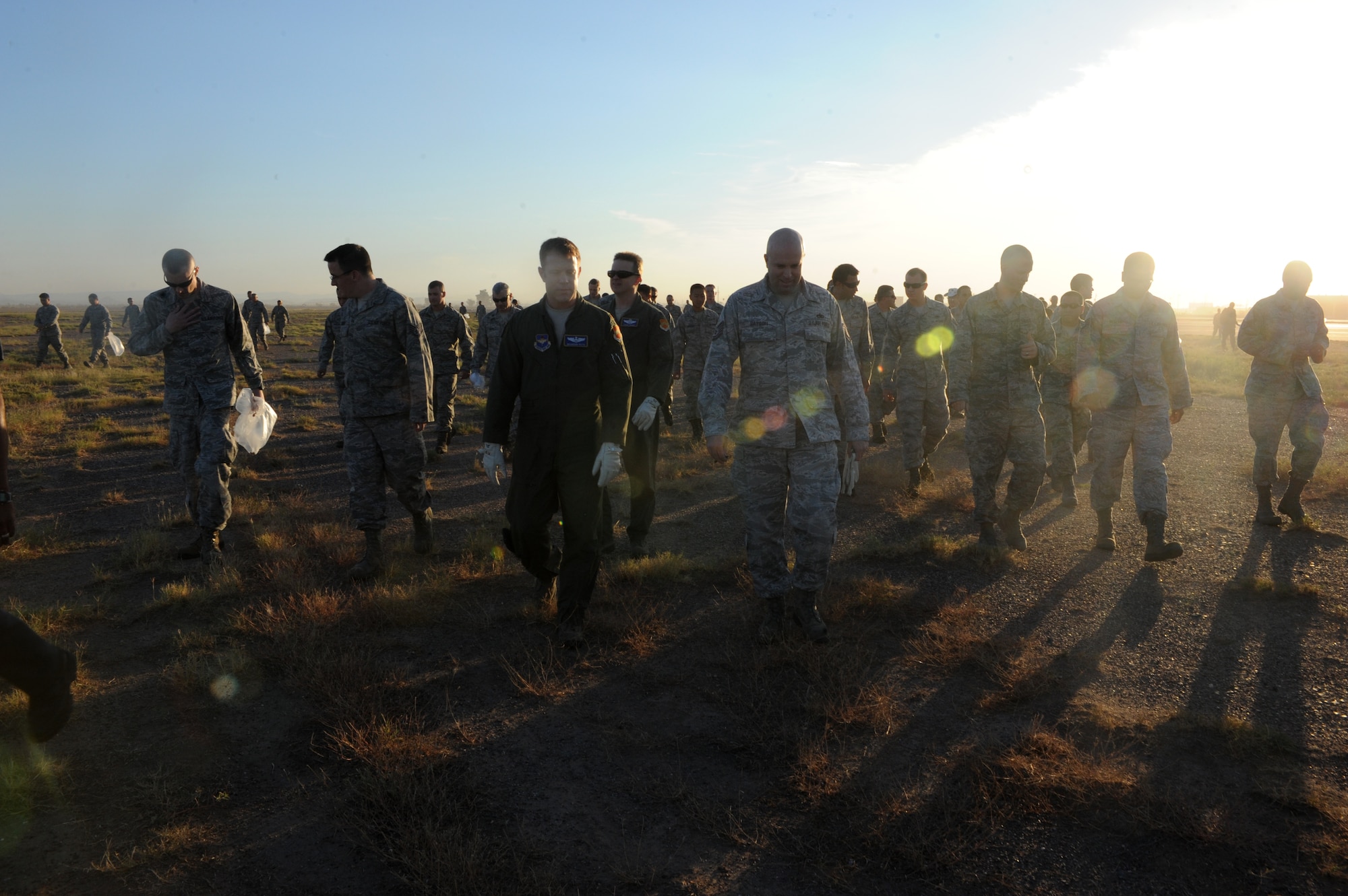 Members of the 56th Fighter Wing perform a foreign object debris walk on the flightline at Luke Air Force Base, Ariz., Sept. 27, 2012. FOD is any kind of debris that can potentially cause damage to an F-16. (U.S. Air Force photo by Airman 1st Class Devante Williams)