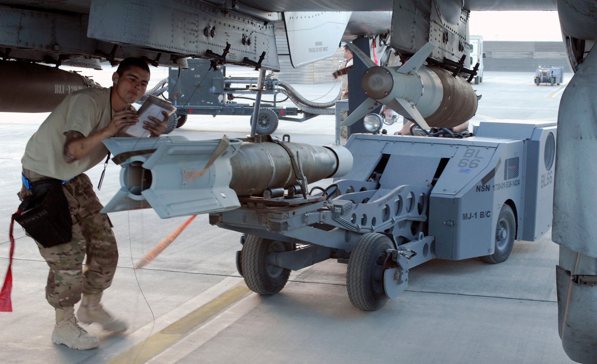 Weapon loaders from the 455th Expeditionary Aircraft Maintenance Squadron arm a newly arrived A-10 Thunderbolt IIs from Davis-Monthan Air Force Base’s 354th Fighter Squadron at Bagram Air Field, Afghanistan, Oct. 3, 2012. Affectionately called the ‘Warthog’, the A-10 is a specialized ground-attack aircraft which provides close air support to ground forces operating in Afghanistan. (U.S. Air Force Photo/Staff Sgt. Jeff Nevison)