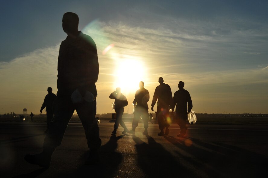 Members of the 56th Fighter Wing perform a foreign object debris walk Sept. 27 on the flighline. FOD is a substance, debris or article that can potentially cause damage to an F-16. (U.S. Air Force photo by Senior Airman Sandra Welch) 