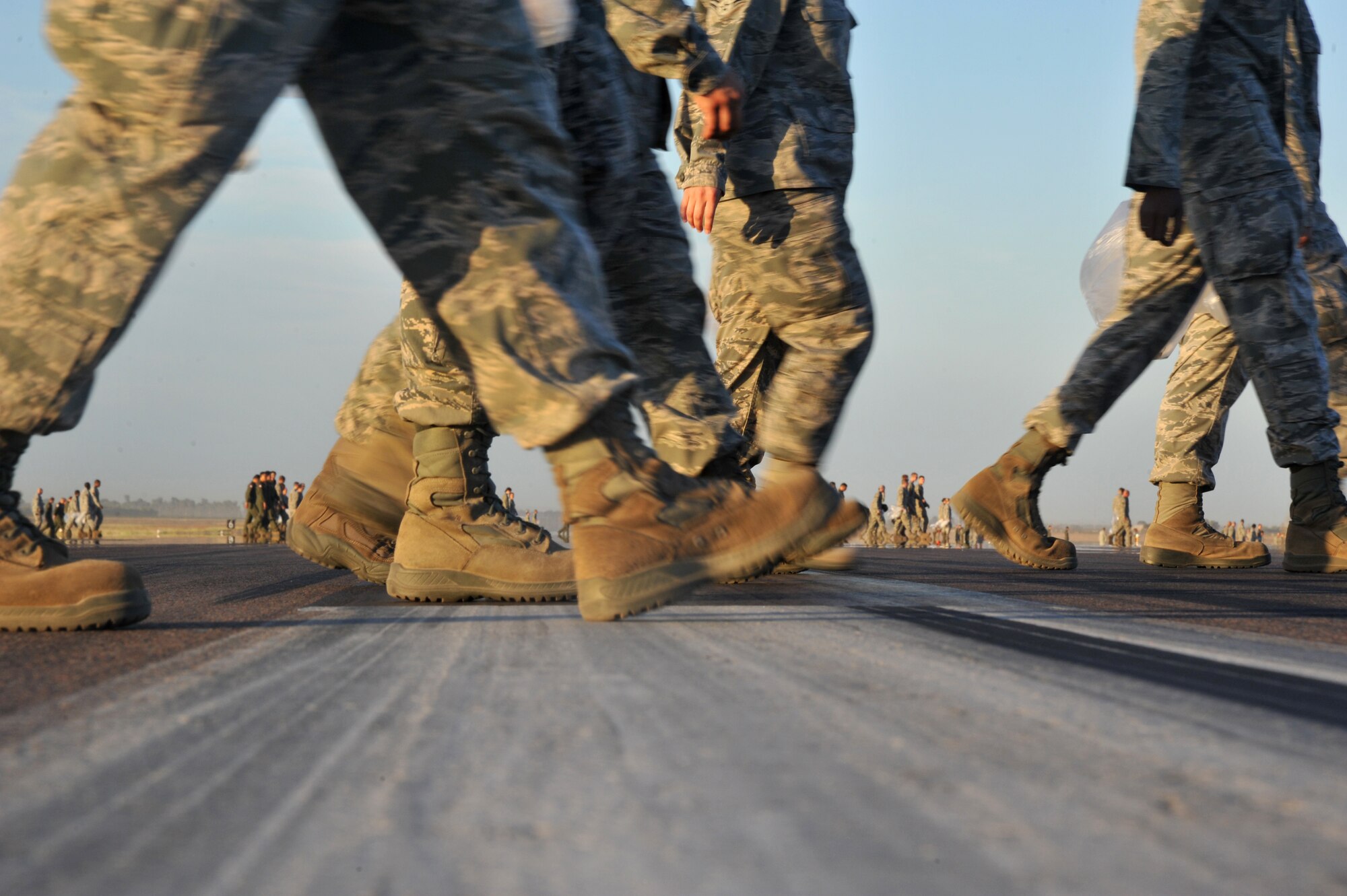 Members of the 56th Fighter Wing perform a foreign object debris walk Sept. 27 on the flighline. FOD is a substance, debris or article that can potentially cause damage to an F-16. (U.S. Air Force photo by Senior Airman Sandra Welch) 