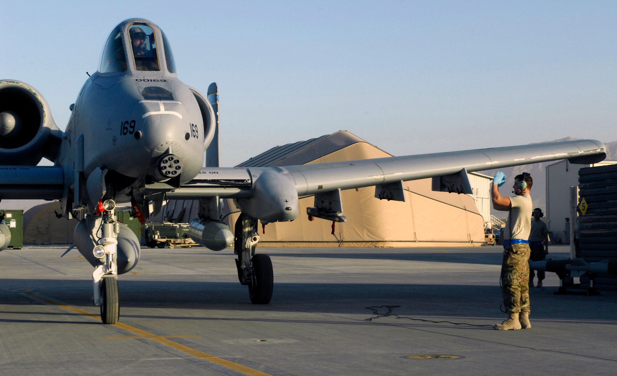 An aircraft maintainer from the 455th Expeditionary Aircraft Maintenance Squadron marshals a U.S. Air Force A-10 Thunderbolt II from Davis-Monthan Air Force Base’s 354th Fighter Squadron to its parking spot at Bagram Air Field, Afghanistan, Oct. 3, 2012. Davis-Monthan pilots and maintainers are some of the newest members of the 455th Air Expeditionary Wing. (U.S. Air Force Photo/Staff Sgt. Jeff Nevison)