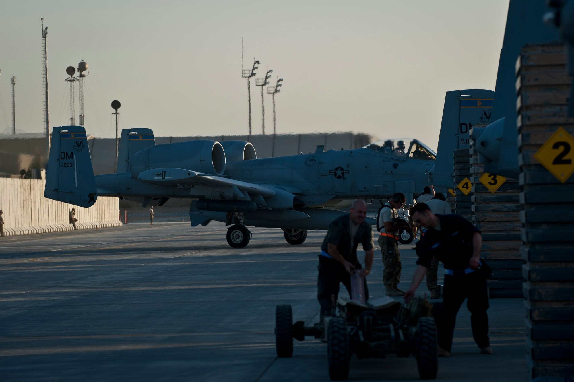 A U.S. Air Force A-10 Thunderbolt II from Davis-Monthan Air Force Base’s 354th Fighter Squadron taxis to its parking spot as Airmen from the 455th Expeditionary Aircraft Maintenance Squadron off load and arm aircraft at Bagram Air Field, Afghanistan, Oct. 3, 2012. The 354 FS ‘Bulldogs’ are relieving Bagram’s current team of Arkansas and Maryland Air National Guard A-10 aircrews and will soon take on the mission of providing daily close-air support to NATO and Afghan ground forces operating in Afghanistan. (U.S. Air Force Photo/Capt. Raymond Geoffroy)