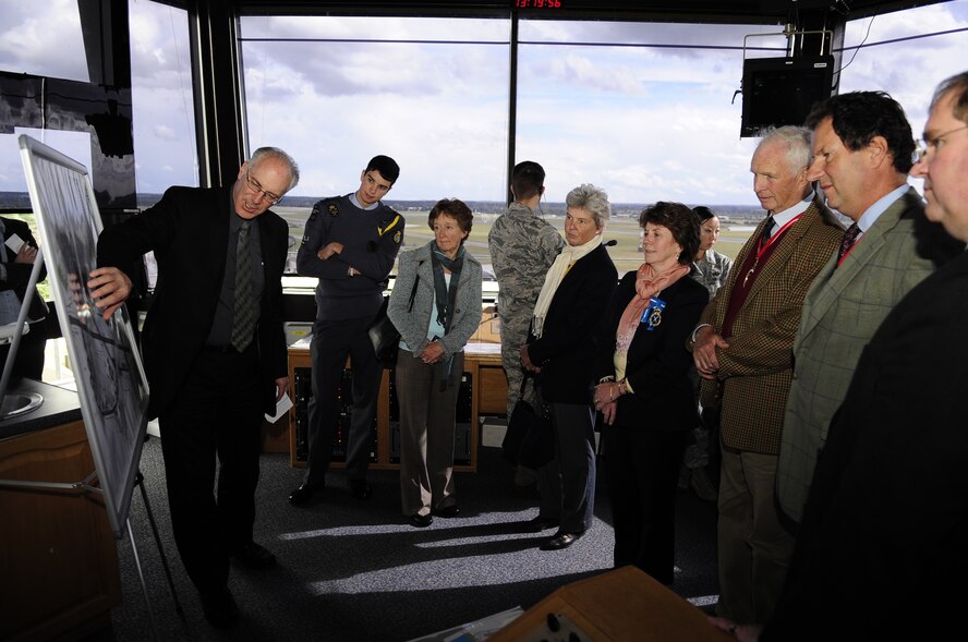 RAF MILDENHALL, England –Martin Lewis, 100th Civil Engineer Squadron, briefs the High Sheriffs of Suffolk, Norfolk and Cambridgeshire, England and their spouses on the air traffic control tower operations during a base tour Sept. 25, 2012, at RAF Mildenhall. The High Sheriffs and their spouses toured the air traffic control tower, the 100th Maintenance Group, a KC-135 Stratotanker, a flight simulator and also toured RAF Lakenheath as part of an information tour. (U.S. Air Force photo/Senior Airman Ethan Morgan)