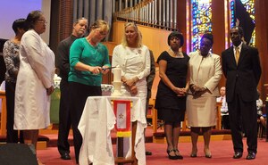 Kathy Bredlau (in green, lighting candle) joins fellow Gold Star Mothers in lighting a candle in remembrance of fallen Service members during the Gold Star Mothers Day ceremony at the Regimental Memorial Chapel at Fort Eustis, Va., Sept. 30, 2012. Bredlau's son, U.S. Army Spc. Josh Bredlau, was killed in action Aug. 23, 2009 while deployed to Iraq. Gold Star Mothers Day is celebrated annually on the last Sunday in September to pay homage to the those who have lost a son or daughter while serving is the Armed Forces. (U.S. Air Force photo by Senior Airman Jason J. Brown/Released)