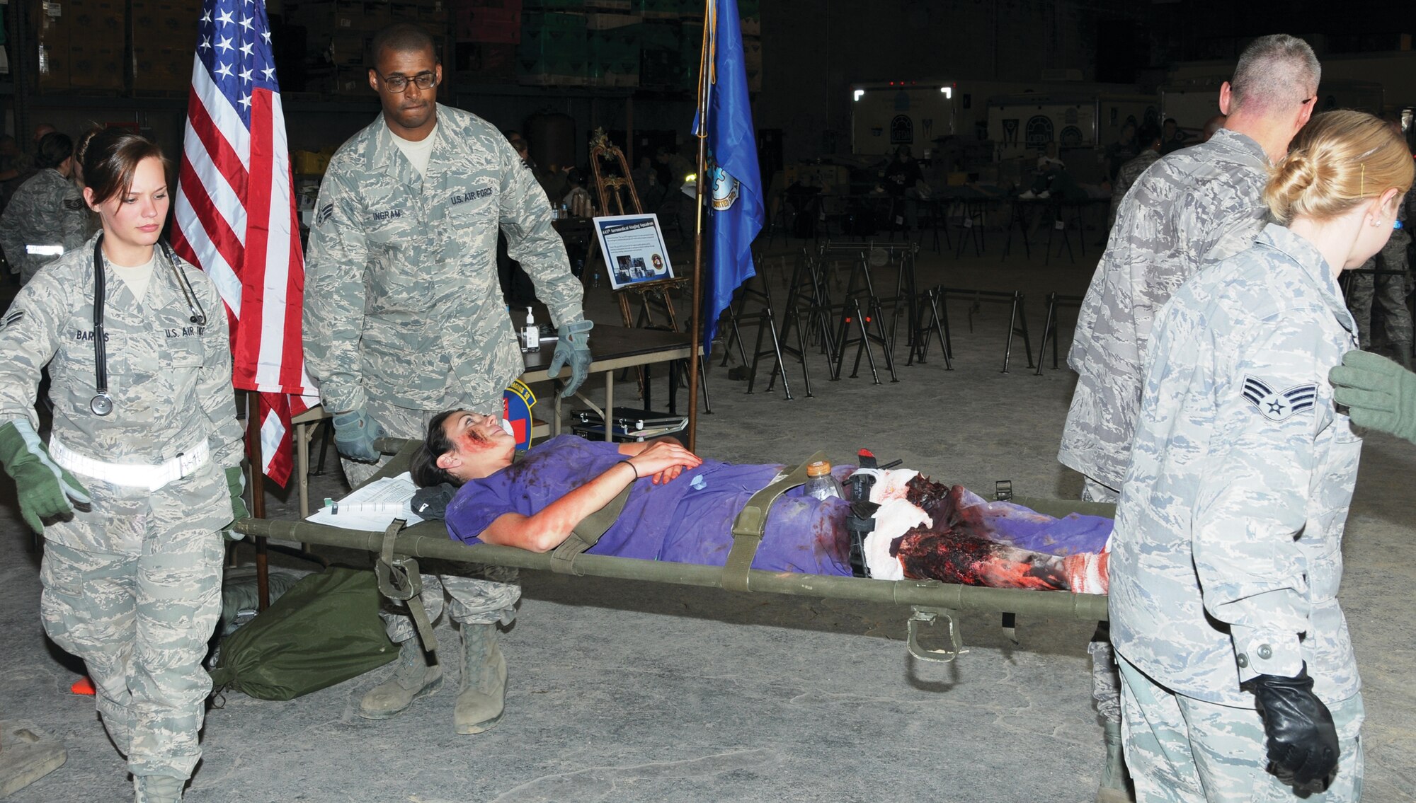 Airman First Class Danielle Barnes, 445th Aeromedical Staging Squadron  dietary therapy helper , Senior Airman Jack Ingram, 445th AMDS medical laboratory technician, and other medical personnel transport an “injured patient” during the disaster response exercise Sept.  9. (Capt.  John Stamm)