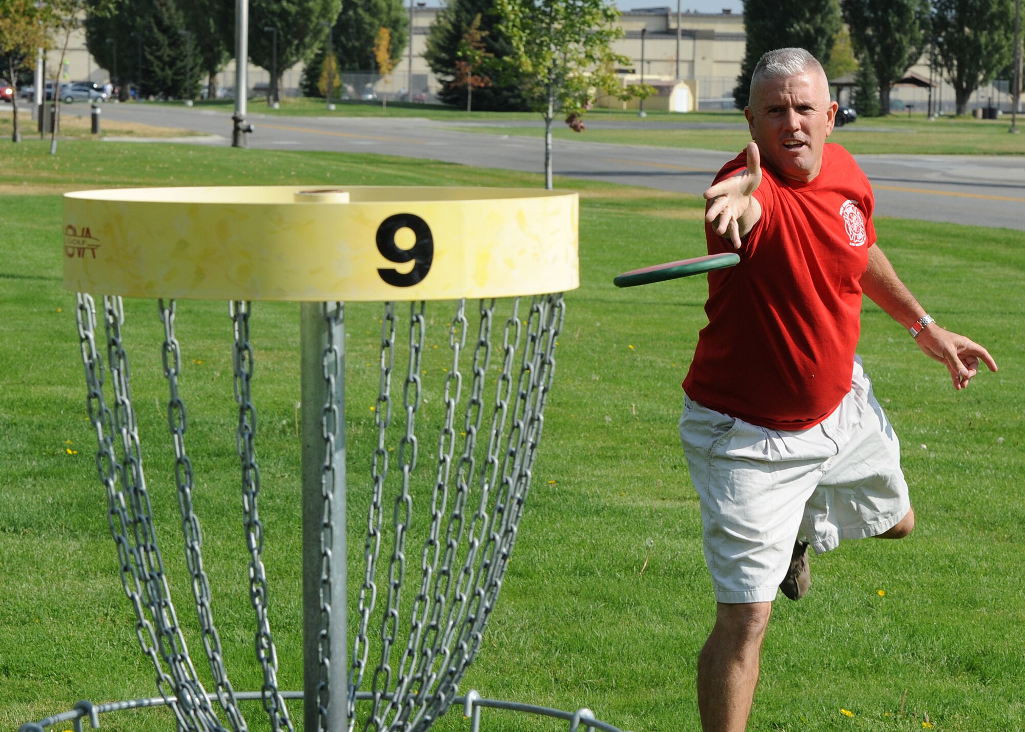 Tech. Sgt. Larry C. Kirk, 144th Maintenance Squadron aerospace ground equipment technician, throws for a birdie at the nine-hole disc golf course at Miller Park on Fairchild Air Force Base, Wash., Oct. 1, 2012. Kirk traveled more than 13,000 miles by vehicle during the period of July through Oct. (U.S. Air Force photo by Staff Sgt. Michael Means)