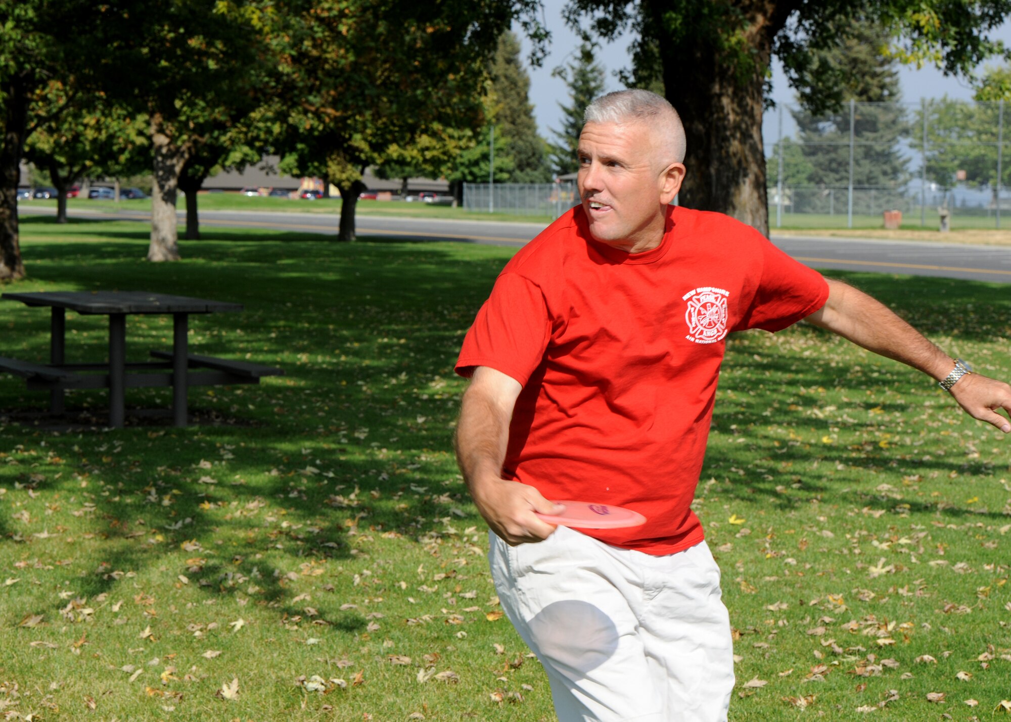 Tech. Sgt. Larry C. Kirk, 144th Maintenance Squadron aerospace ground equipment technician, tees off playing the nine-hole disc golf course at Miller Park on Fairchild Air Force Base, Wash., Oct. 1, 2012. Kirk started his first 50 U.S. states tour here 10 years ago and finished his second tour here. (U.S. Air Force photo by Staff Sgt. Michael Means)