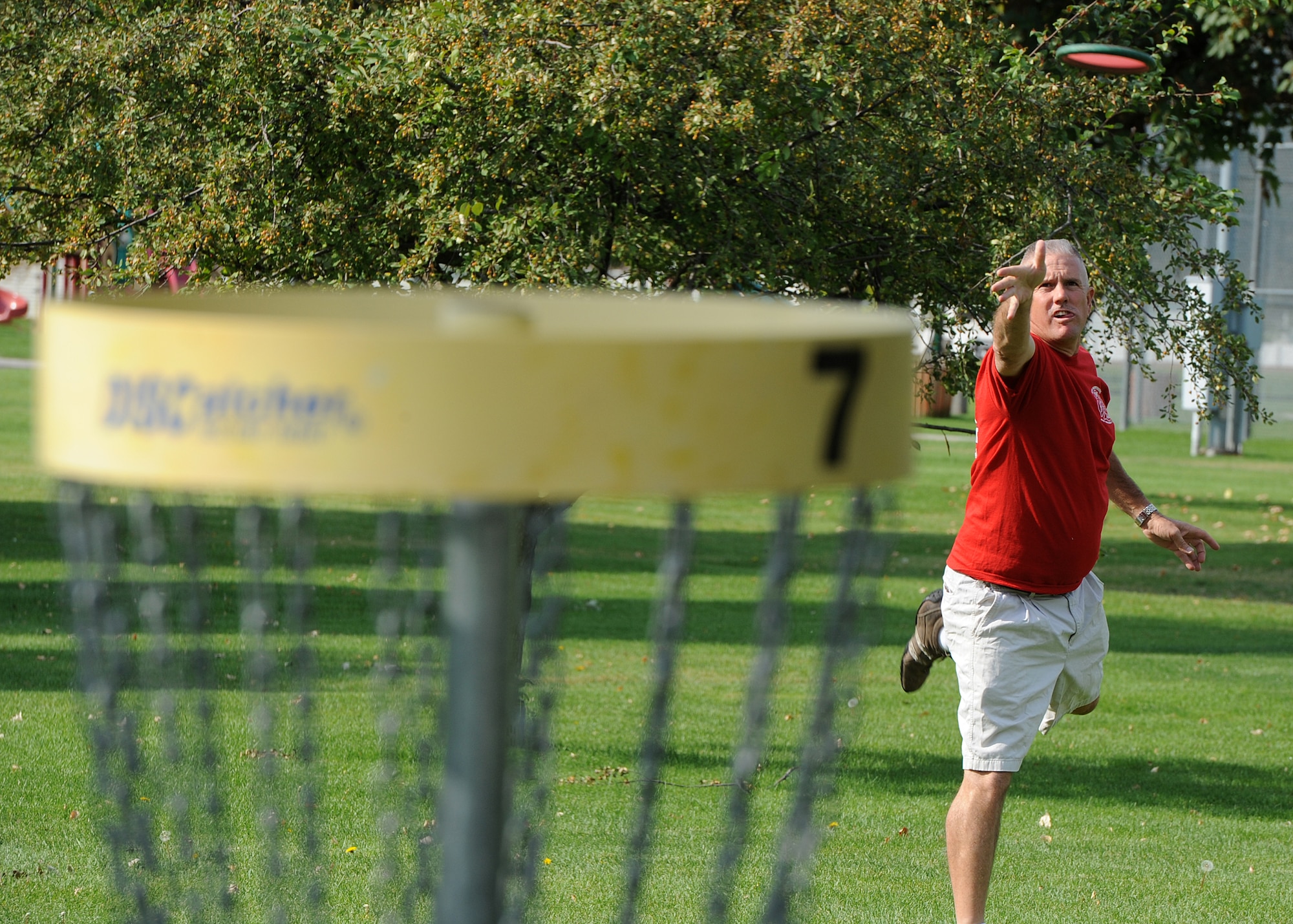 Tech. Sgt. Larry C. Kirk, 144th Maintenance Squadron aerospace ground equipment technician, throws for a birdie at the nine-hole disc golf course at Miller Park on Fairchild Air Force Base, Wash., Oct. 1, 2012. Kirk is with the California Air National Guard in Fresno, Calif. (U.S. Air Force photo by Staff Sgt. Michael Means)