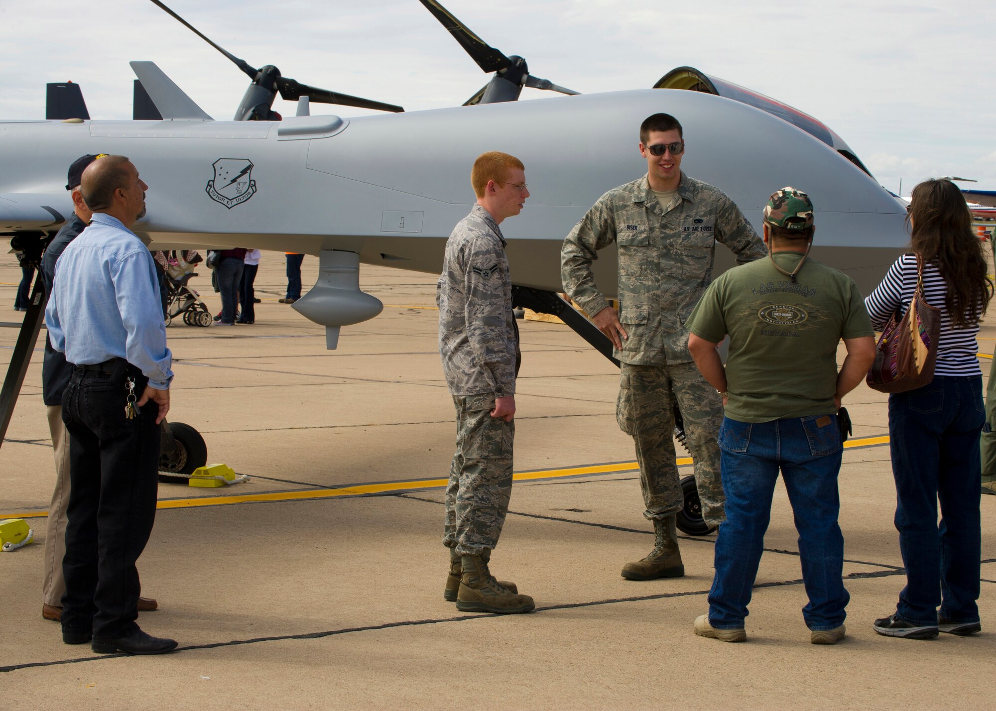 Airmen 1st Class Christopher Frantz and Joshua Bisek, 849th Aircraft Maintenance Squadron crew chiefs, speak to the public about the capabilities of the MQ-1B Predator at the New Mexico Centennial Air Tour in Roswell, N.M., Sept. 29. The Predator has flown a countless number of missions over the Middle Eastern area of responsibility. This is only the second time a Predator has been displayed in a public setting for viewing. (U.S. Air Force photo by Airman 1st Class Michael Shoemaker/Released)