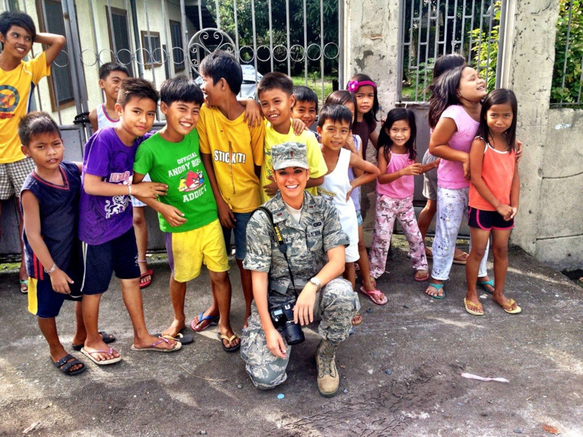 Second Lieutenant Sarah Bergstein poses with children from Cacutud Elementary school near Basa, Phillipines. Bergstein was there as part of Pacific Unity 12-6, during which Airmen from Joint Base Pearl Harbor-Hickham joined with their counterparts in the Phillipine air force as well as local contractors to renovate and help build a school. (U.S. Air Force photo)