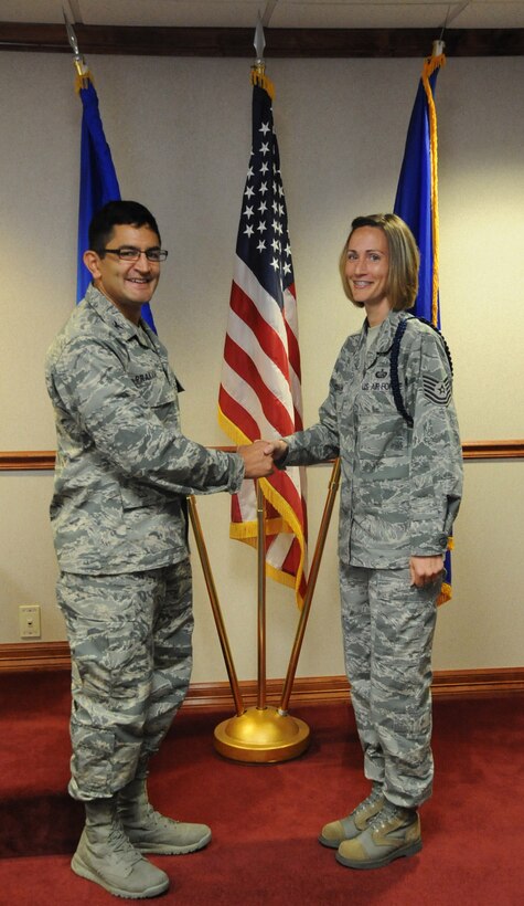 Col. Om. Prakash (left), 82nd Training Wing vice-commander,
congratulates Tech. Sgt. Sarah Hardison, 362nd Training
Squadron, for being selected as the "Commander's Wingman of the Week" award
winner for the week of Oct. 1-5 during the wing staff meeting at Sheppard
Air Force Base, Texas, on Oct. 3, 2012. (U.S. Air Force Photo/Kimberly
Parker)  
