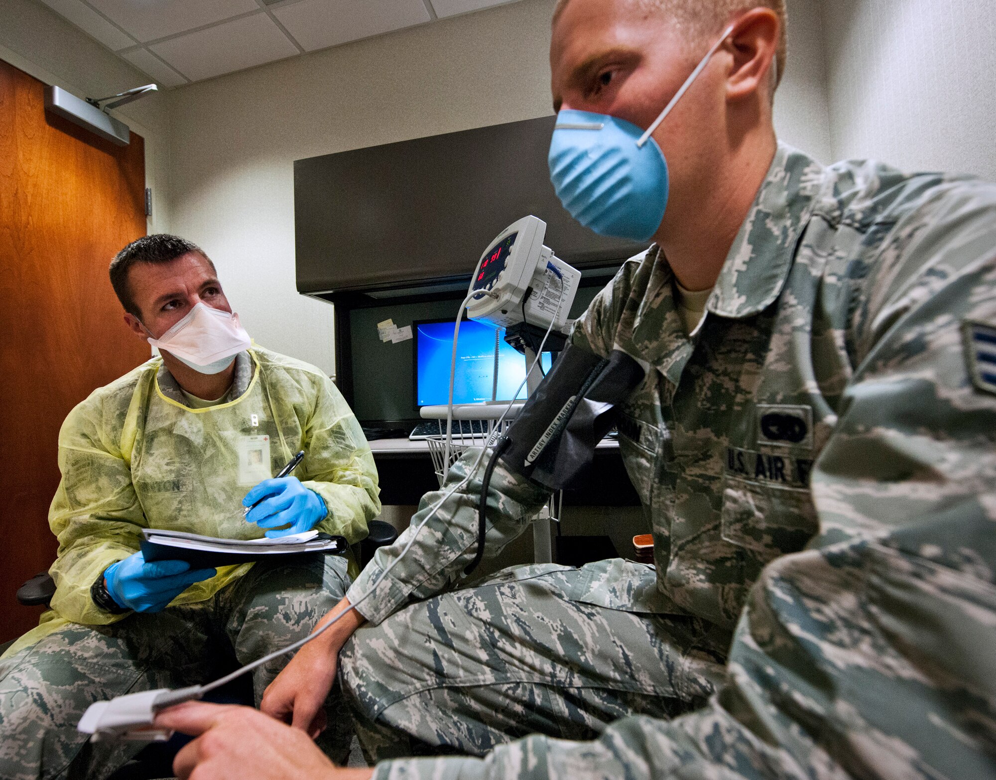 Staff Sgt. James Thornton, of the 96th Medical Group, interviews a patient as part of a case investigation of personnel reporting flu-like symptoms as part of a disease containment exercise Oct. 2 at Eglin Air Force Base, Fla.  The week-long exercise was to measure the base’s response to a medical/biological emergency.  (U.S. Air Force photo/Samuel King Jr.)