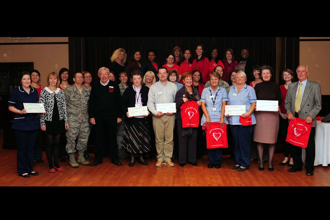 RAF MENWITH HILL, United Kingdom - Members of the Menwith Hill Station Community Heartbeat pose for a picture with check recipients after an annual community-giving event at RAF Menwith Hill Sept. 28. The MHS Community Heartbeat donated more than £3,000 to five local charities and organizations including the Yorkshire Air Ambulance, Harrogate Citizens Advice Bureau, St. Michaels’ Hospice, Harrogate District Hospital Maternity Unit and Spire Hospital Cancer Treatment Centre. Heartbeat has donated more than $41,750 this year. (U.S. Air Force photo by Staff Sgt. Debbie Lockhart)