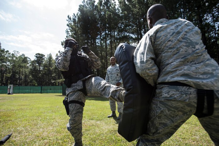Staff Sgt. Ellis Bowles, 628th Security Forces Squadron, performs a “spartan” kick during a combative training session prior to an active shooter scenario Sept. 26, 2012, at Joint Base Charleston - Weapons Station, S.C. During the scenario, Airmen practiced entering a house under control of hostile forces and eliminated the threat while identifying and controlling non-hostile inhabitants. Security Forces Airmen test their skills and knowledge in simulated hostile environments to prepare for real-world events. (U.S. Air Force photo/Staff Sgt. Rasheen Douglas)