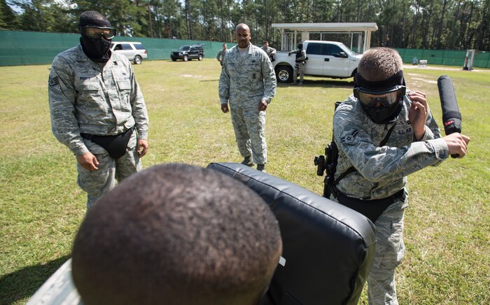 Airman 1st Class Robert Loftin, 628th Security Forces Squadron, strikes an "adversary" to control a dangerous situation with an expandable baton during a combative training session prior to an active shooter scenario Sept. 26, 12, at Joint Base Charleston - Weapons Station, S.C. Expandable batons are used to de-escalate a situation with the least amount of force necessary. The expandable batons are one of the tools Airmen use as a non-lethal means to defend themselves. (U.S. Air Force photo/Staff Sgt. Rasheen Douglas)