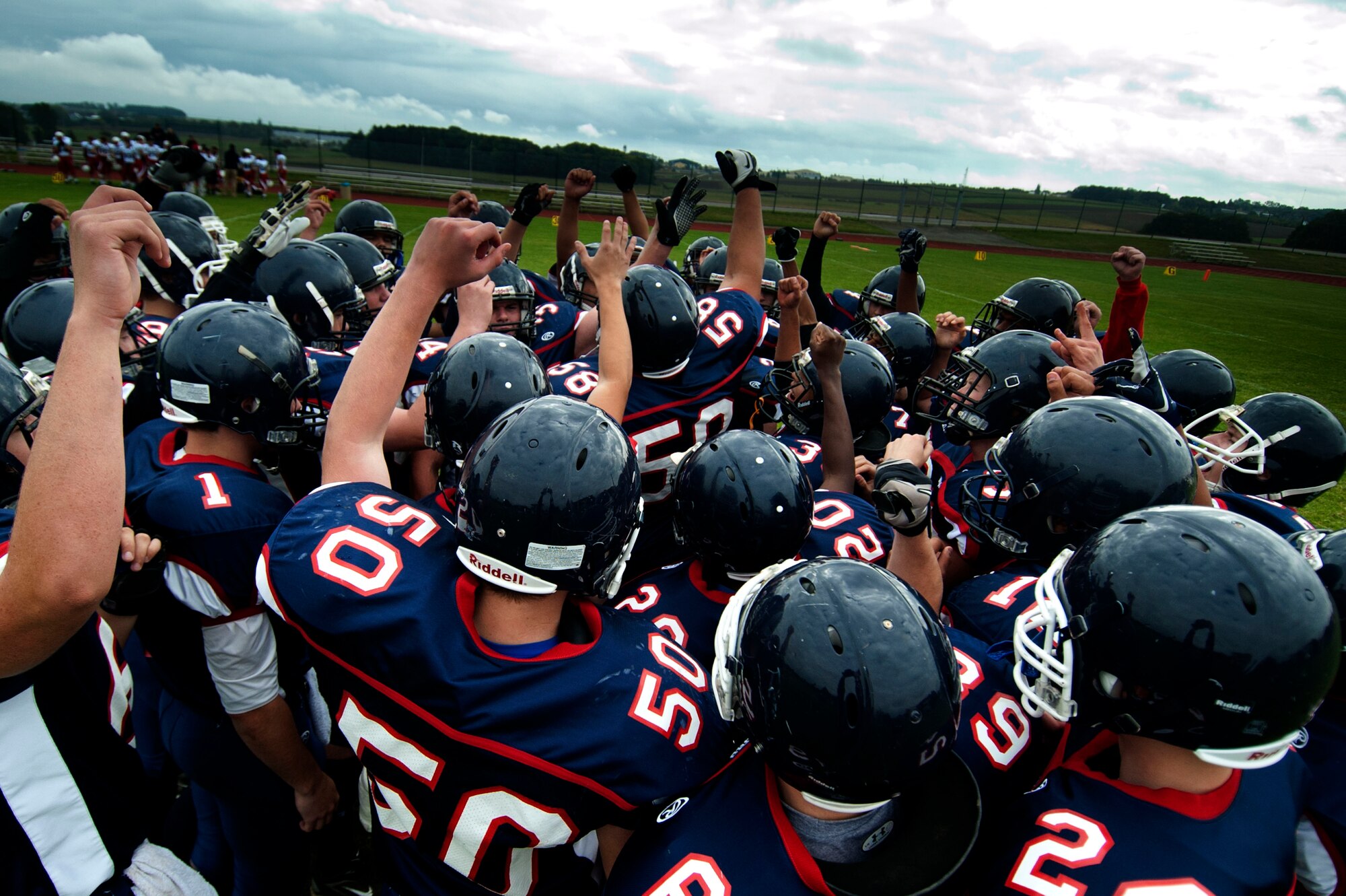 BITBURG ANNEX, Germany – The Bitburg Barons motivate each other before their game against the International School of Brussels Raiders at Bitburg High School Sept. 29.  The referees stopped the homecoming game at the half after the Barons achieved a commanding lead of 42-0. (U.S. Air Force photo by Airman 1st Class Gustavo Castillo/Released)