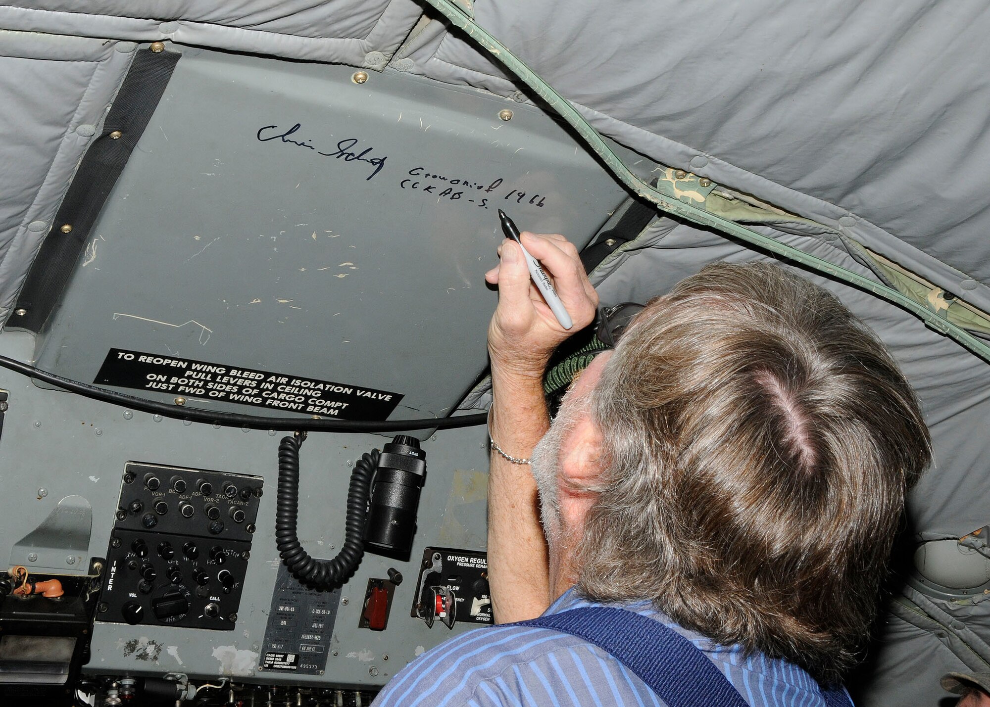 Mr. Christopher Schutz, a former crew chief who served in Vietnam, signs his name on the interior of a C-130E Hercules on display at the Air Park at the 182nd Airlift Wing in Peoria, Ill. on Sep. 26, 2012. (U.S. Air Force photo by Tech. Sgt. Todd Pendleton/Released.)