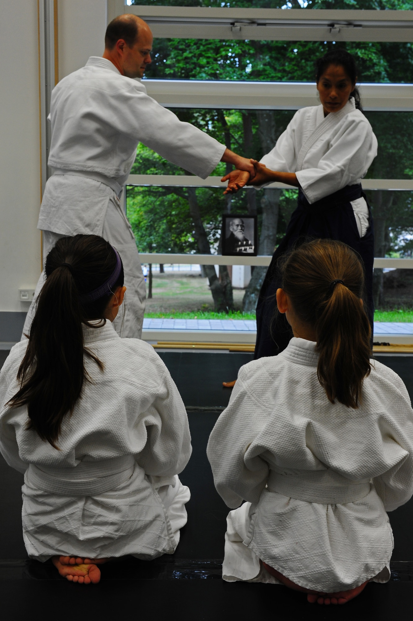 Silvia Eschenlauer, Ramstein Youth Center Aikido instructor, demonstrates defense techniques to a youth Aikido class on Ramstein Air Base, Germany, Sept. 11, 2012. Eschenlauer teaches Aikido to children of the Kaiserslautern Military Community Tuesdays 5:45 to 6:30p.m. and 6:30 to 7:15p.m. (U.S. Air Force photo/Airman 1st Class Holly Cook)