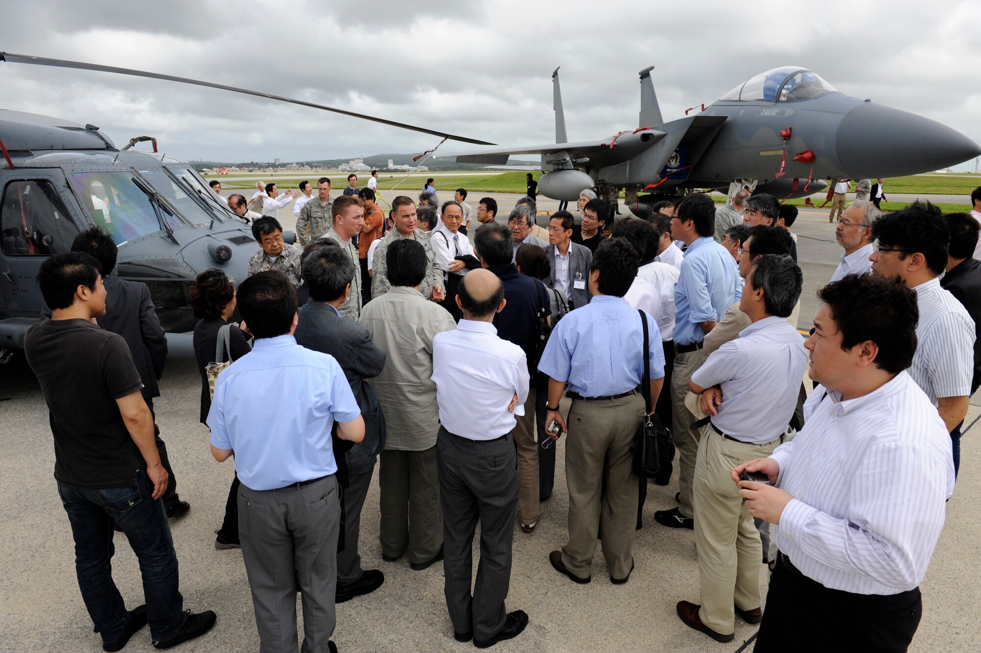 U.S. Air Force Lt. Col. Glen Frazier, 31st Rescue Squadron commander, speaks with Japanese media members during an orientation tour of Kadena Air Base, Japan, Sept. 28, 2012. One hundred sixty Japanese reporters attending the 56th annual National Council to Promote Ethics of Mass Media conference visited Kadena to learn about the 18th Wing's strategic importance and mission. The journalists were briefed on Kadena's mission by U.S. Air Force Brig. Gen. Matt Molloy, 18th Wing commander, before then viewing a static display of a U.S. Air Force HH-60 Pave Hawk helicopter and anF-15 Eagle fighter aircraft. (U.S. Air Force photo/ Senior Airman Maeson L. Elleman)