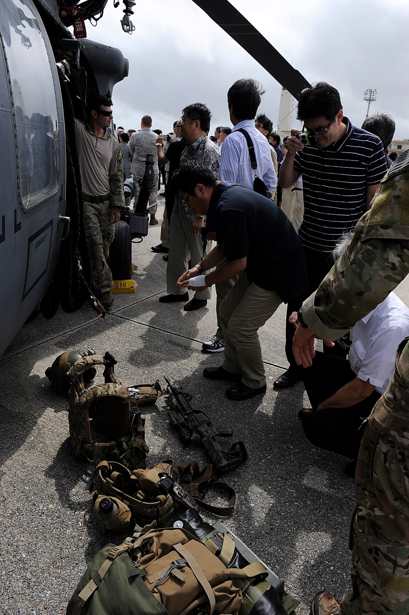 Reporters from Japanese media organizations receive a tour of a U.S. Air Force HH-60 Pave Hawk helicopter and pararescue equipment during an orientation visit to Kadena Air Base, Japan, Sept. 28, 2012. One hundred sixty Japanese reporters attending the 56th annual National Council to Promote Ethics of Mass Media conference visited Kadena to learn about the 18th Wing's strategic importance and mission. The journalists were briefed on Kadena's mission by U.S. Air Force Brig. Gen. Matt Molloy, 18th Wing commander, before then viewing a static display of a U.S. Air Force HH-60 Pave Hawk helicopter and an F-15 Eagle fighter aircraft. (U.S. Air Force photo/ Senior Airman Maeson L. Elleman)