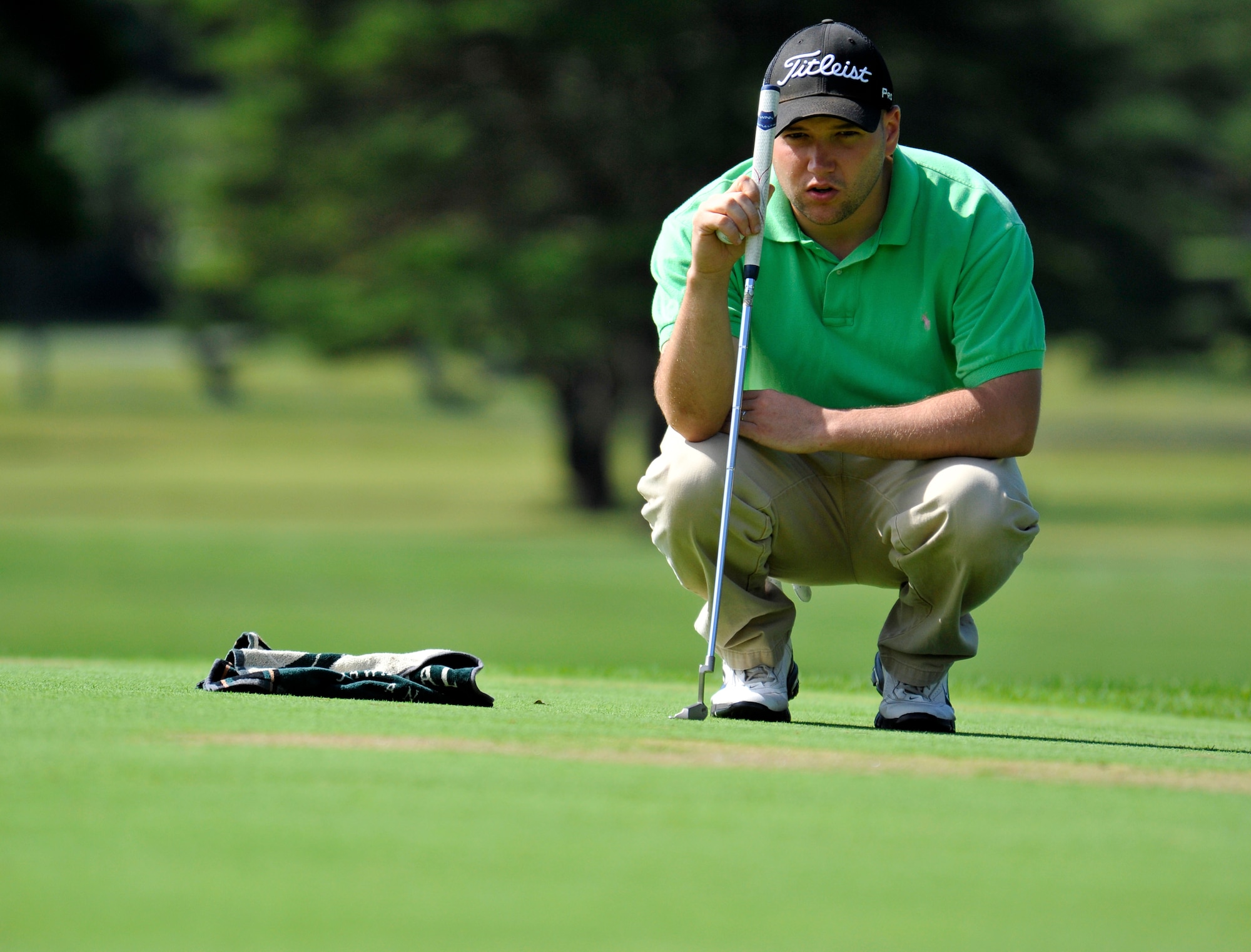 Matt Auman, 35th Maintenance Squadron golf team member, reads the green before putting during the intramural golf championship at Misawa Air Base, Japan, Oct. 1, 2012. Both teams finished even for the day, but the 35 MXS won the match by winning the first sudden-death playoff hole. (U.S. Air Force photo by Airman 1st Class Zachary Kee)
