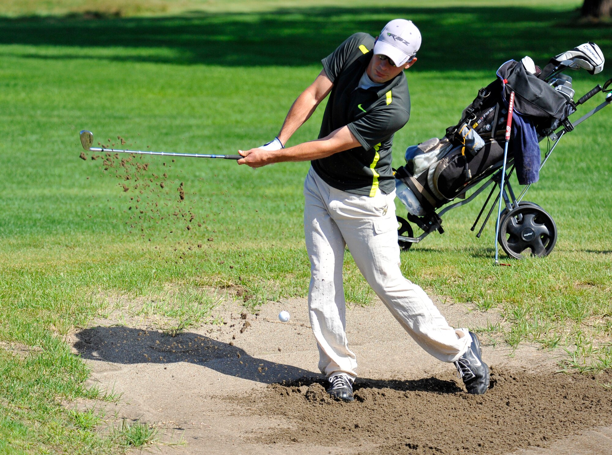 Dale Mitchell, 373rd Support Squadron golf team member, uses a wedge to get his ball out of a sand trap during the intramural golf championship at Misawa Air Base, Japan, Oct. 1, 2012. The match was played at the Gosser Memorial Golf Course and featured the 373 SPTS and the 35th Maintenance Squadron. The 35 MXS defeated 373 SPTS in a sudden-death playoff hole that came after both teams finished even on the day. (U.S. Air Force photo by Airman 1st Class Zachary Kee)