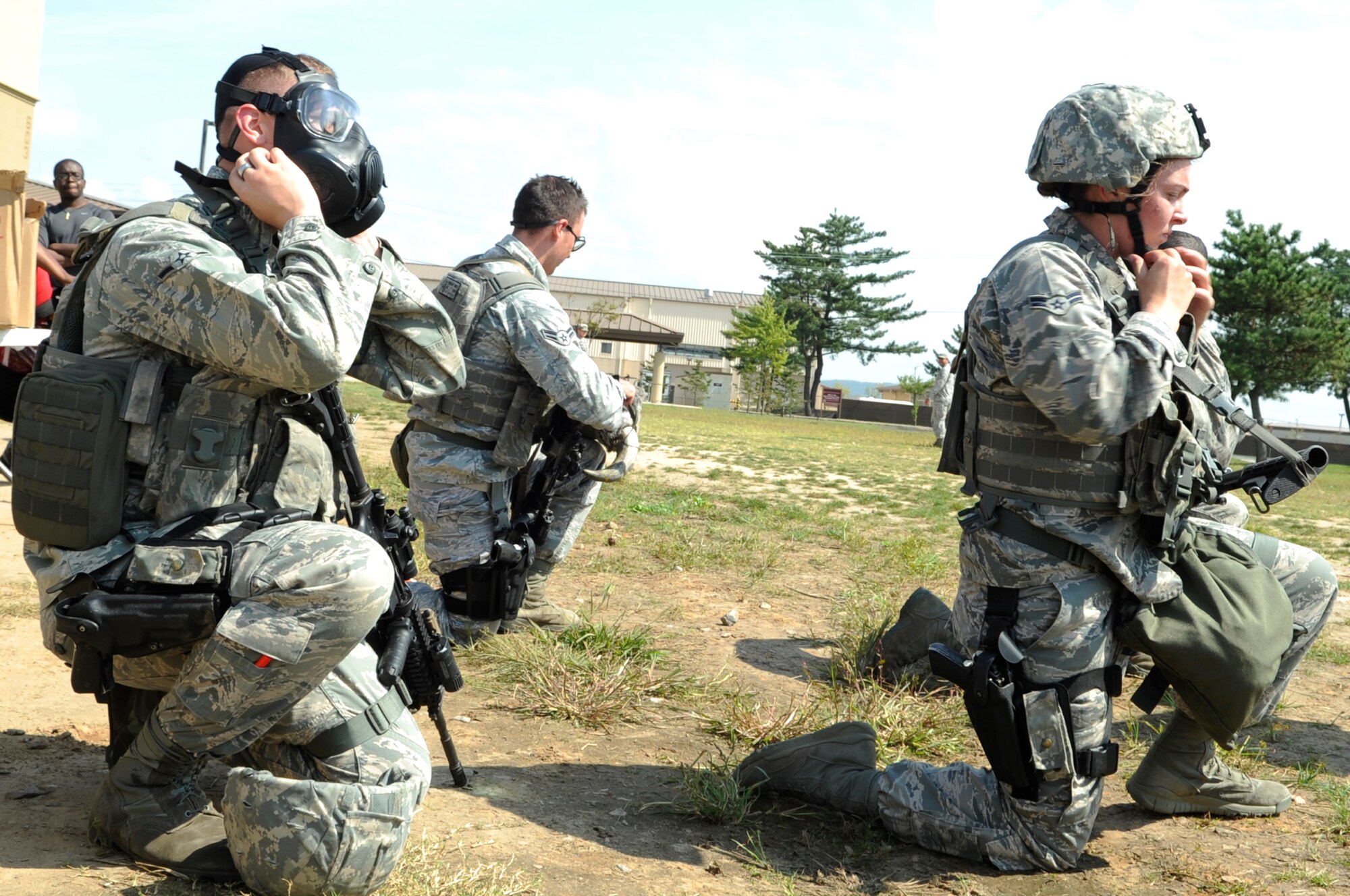 Competitors from the 8th Security Forces Squadron take off their gas masks before moving onto the next leg of the Defenders Challenge held Sept. 28, 2012, at Kunsan Air Base, Republic of Korea. As part of the challenge, competitors donned their gas masks and sprint around a field before assembling an M4 carbine and function-checking an M9 handgun. (U.S. Air Force photo/Senior Airman Brigitte N. Brantley)
