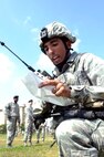 Airman 1st Class Ryan Salas, 8th Security Forces Squadron Bravo flight, tests a newly-programmed radio during the first event of the Defenders Challenge held Sept. 28, 2012, at Kunsan Air Base, Republic of Korea. Teams were timed on their ability to complete an obstacle course as they highlighted combat skills learned during recent training. (U.S. Air Force photo/Senior Airman Brigitte N. Brantley)
