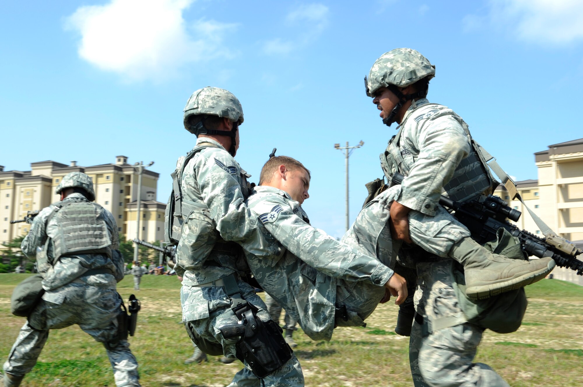 Competitors from the 8th Security Forces Squadron move an injured comrade during the last leg of the Defenders Challenge held Sept. 28, 2012, at Kunsan Air Base, Republic of Korea. This was just one of many skills on which teams were tested. (U.S. Air Force photo/Senior Airman Brigitte N. Brantley)
