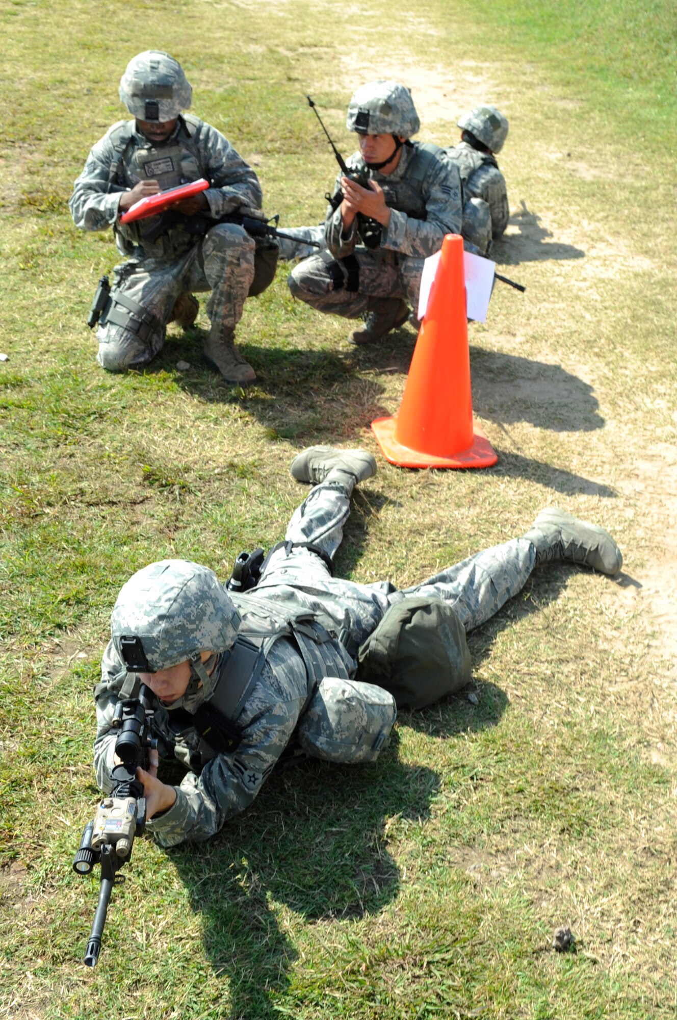 Members from the 8th Security Forces Squadron Commandos flight show their proficiency in reading range cards and programming radios during the Defenders Challenge Sept. 28, 2012, at Kunsan Air Base, Republic of Korea. Each of the six teams had to perform nine actions, including sprinting in a gas mask and administering self-aid and buddy care.  (U.S. Air Force photo/Senior Airman Brigitte N. Brantley)