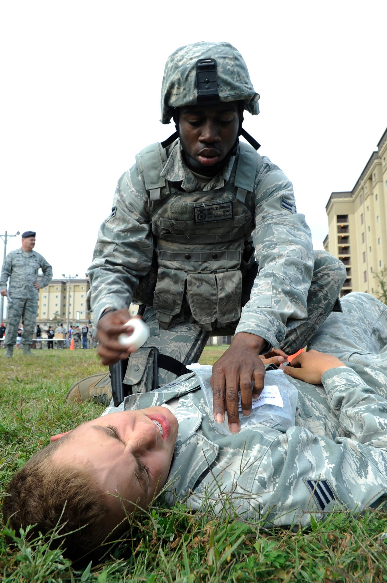 Airman 1st Class Nevelle Simmons, 8th Security Force Squadron Barbarians flight, seals off a simulated sucking chest wound during the Defenders Challenge Sept. 28, 2012, at Kunsan Air Base, Republic of Korea. Self-aid and buddy care was just one of many skills SFS members were tested on during the challenge. (U.S. Air Force photo/Senior Airman Brigitte N. Brantley)