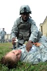 Airman 1st Class Nevelle Simmons, 8th Security Force Squadron Barbarians flight, seals off a simulated sucking chest wound during the Defenders Challenge Sept. 28, 2012, at Kunsan Air Base, Republic of Korea. Self-aid and buddy care was just one of many skills SFS members were tested on during the challenge. (U.S. Air Force photo/Senior Airman Brigitte N. Brantley)