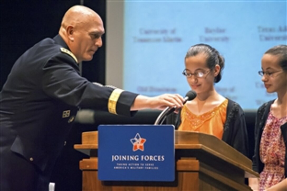Army Chief of Staff Gen. Ray Odierno brings the microphone closer to Felicity and Abigail Horan as they offer observations during a "Joining Forces" campaign event on educating educators at George Mason University in Fairfax, Va., Oct. 3, 2012.  The Horans are military children attending 7th grade in a Fairfax public school.