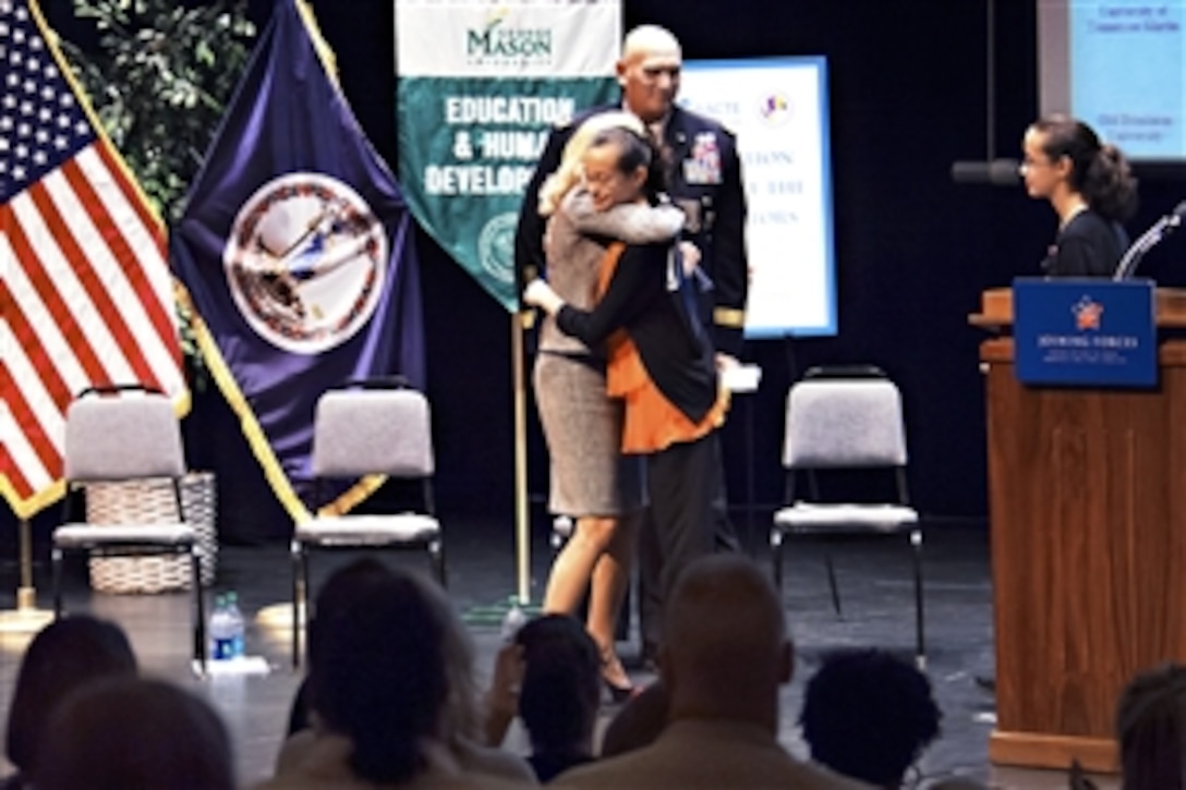 Dr. Jill Biden, wife of Vice President Joe Biden, hugs Felicity Horan after she gave a detailed speech about her experience as a military child during a "Joining Forces" campaign event on educating educators at George Mason University in Fairfax, Va., Oct. 3, 2012.