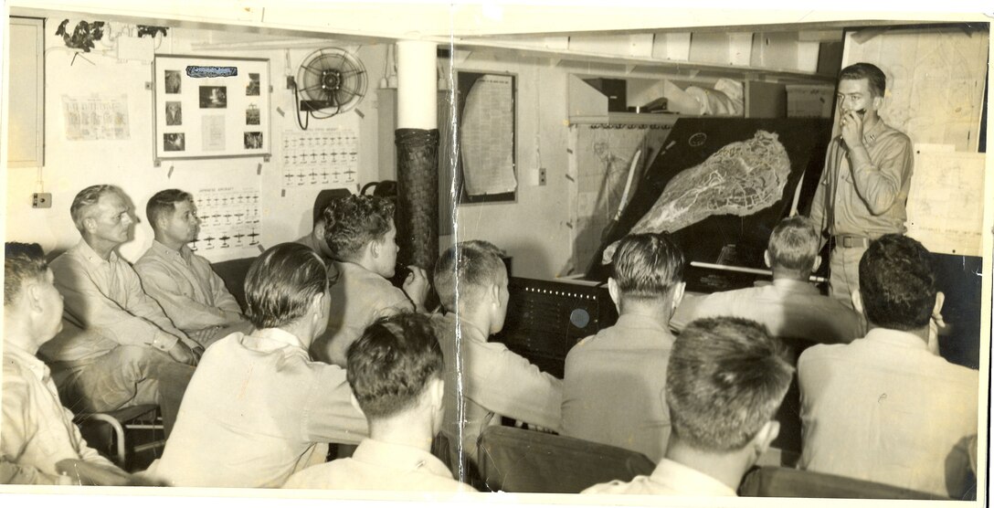 "On transport ship coming back from Saipan-Tinian to Maui. (Capt.) Proehl explaining next mission to Iwo Jima."