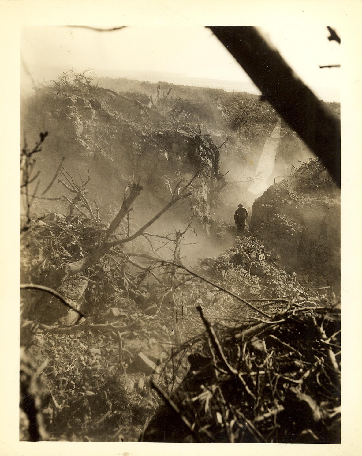 A Marine searches rock crevice for Japanese positions.