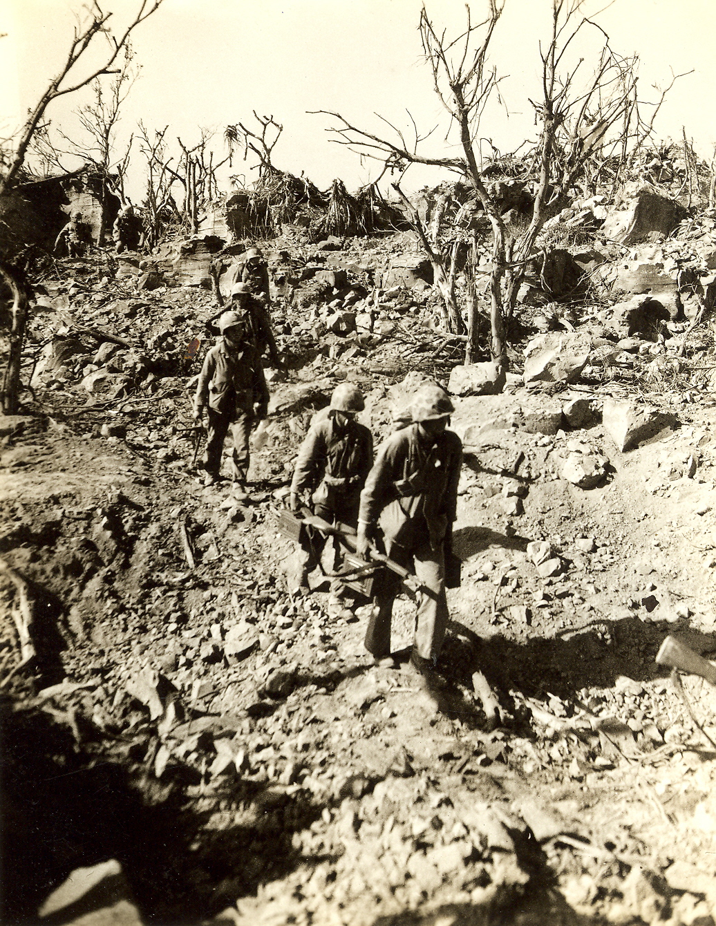Marines move forward with ammunition and machine guns.