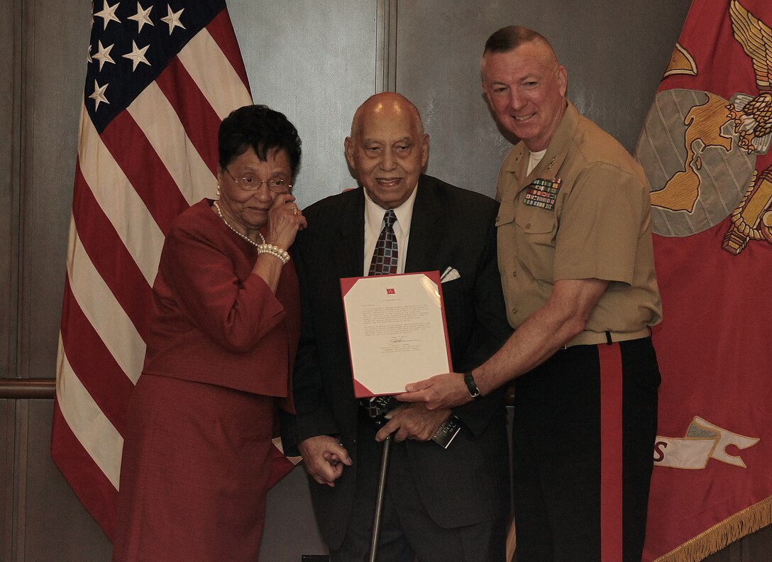 Lt. Gen. Steven A. Hummer, commander of Marine Forces Reserve, presents a letter to accompany the Congressional Gold Medal to Winston Burns Sr. during a ceremony at Marine Corps Support Facility New Orleans Sept. 10. Burns received the medal for his patriotism and sacrifice as one of nearly 20,000 African-American Marines who underwent segregated training in Montford Point, N.C. (U.S. Marine Corps photo by Cpl. Audrey Graham/Released)