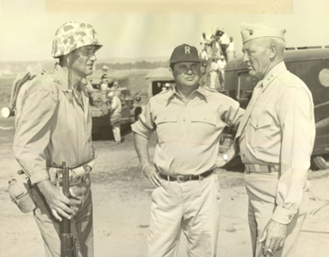 Erskine on the set of the film "The Sands of Iwo Jima."
John Wayne is at left, with director Allan Dwan in the middle. 

