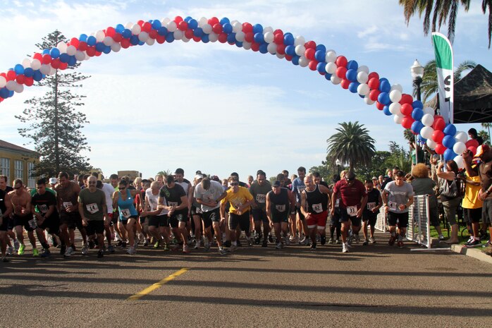 Participants in the 11th annual Boot Camp Challenge take off running Sept. 29 aboard Marine Corps Recruit Depot San Diego. The three-mile course featured 52 obstacles that included walls, logs, trenches and 60 drill instructors to motivate them through the course.
