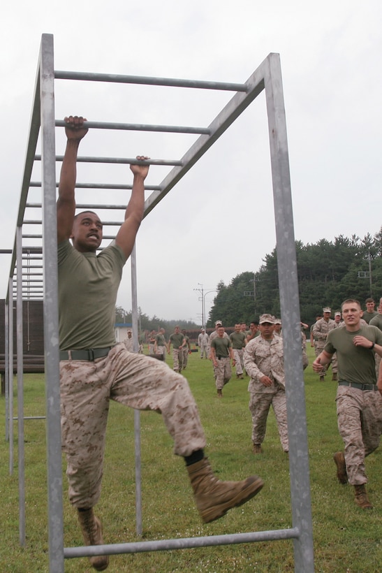 Lance Cpl. Sergio A. Yanez navigates the monkey bars on the confidence course during warrior day at Combined Arms Training Center Camp Fuji Sept. 20. The competitors and spectators showed great sportsmanship and morale during the events, said Yanez. Yanez is a motor vehicle operator with Oscar Battery, 5th Battalion, 14th Marine Regiment, 4th Marine Division, assigned to 3rd Bn., 12th Marines, under the unit deployment program. 
