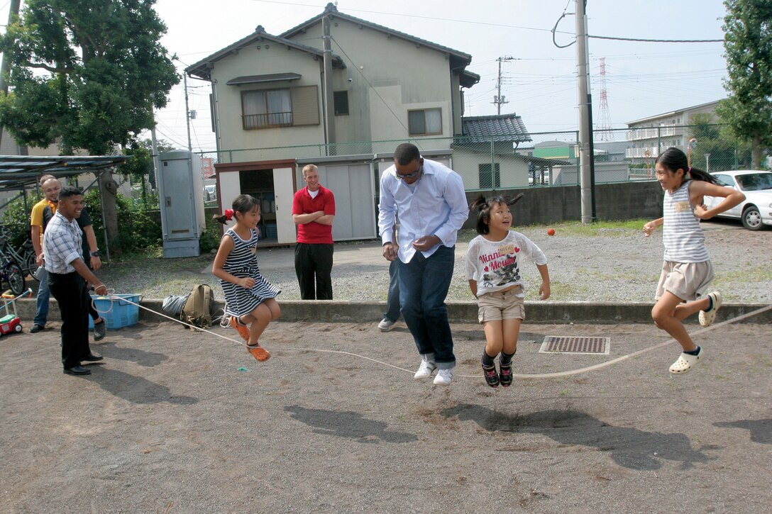 Staff Sgt. Octavius L. Stone jumps rope with children from Seishin Orphanage near the East Fuji Maneuver Area Sept. 22. The Marines and sailors participated in the volunteer event to learn more about the local culture while strengthening relations with the local community. Stone is a field artillery cannoneer with 3rd Battalion, 12th Marine Regiment, 3rd Marine Division, III Marine Expeditionary Force. 