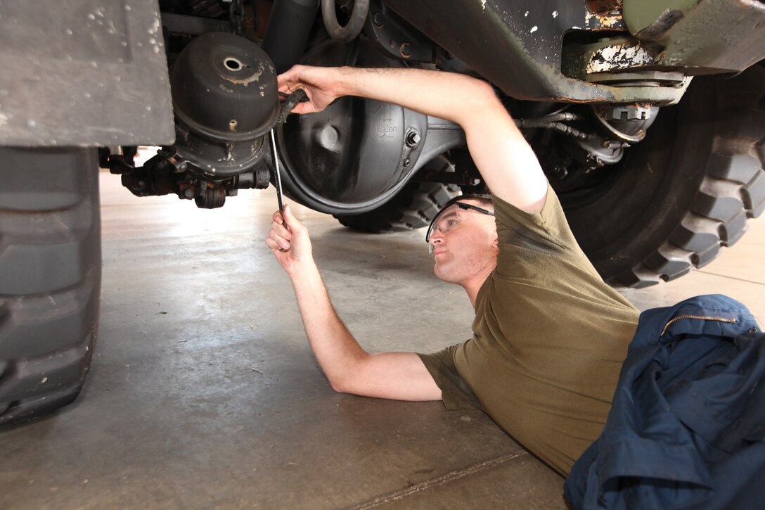 Cpl. Brian R. Carter repairs a tactical vehicle at Camp Kinser Oct. 1. Carter helps maintain III Marine Expeditionary Force’s mission readiness by conducting intermediate maintenance on III MEF vehicles. Carter is an automotive maintenance technician with 3rd Maintenance Battalion, Combat Logistics Regiment 35, 3rd Marine Logistics Group, III MEF. 