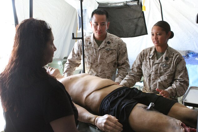 Petty Officer 2nd Class Anthony Chow and Petty Officer 2nd Class Tara Mallari, corpsmen serving with 1st Medical Battalion, instruct how to properly treat casualties of a natural disaster during San Francisco Fleet Week Oct. 3. Fleet Week is dedicated to showing civilians the United States military's capability of humanitarian assistance and disaster response preparedness on the home front.