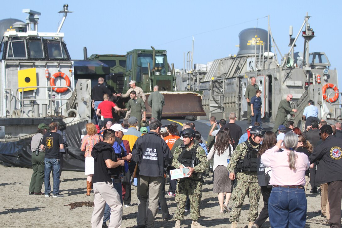 Sailors serving with Beach Master Unit 1 direct San Francisco's emergency responders while they board a Landing Craft Air Cushion with Assault Craft Unit 1 during a beach landing demonstration at Ocean Beach Oct. 3, 2012. Fleet Week is dedicated to showing civilians the United States military's capability of humanitarian assistance and disaster response preparedness on the home front.
