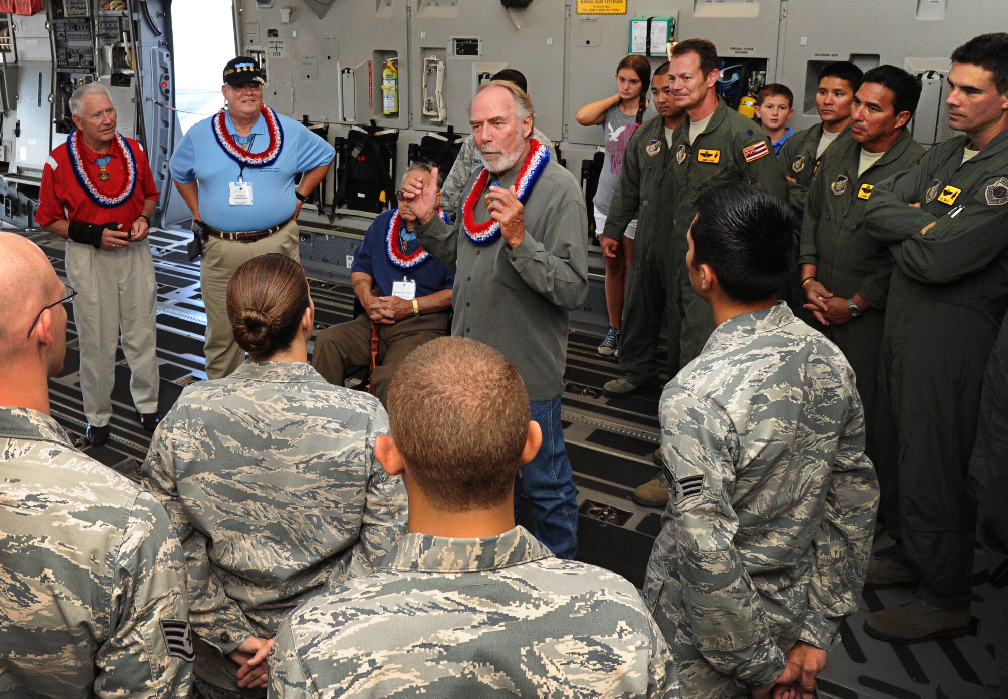 Maj. (Ret.) Drew Dix, a U.S. Army veteran of the Vietnam War and Medal of Honor recipient, speaks to Airmen about his military service while touring a static C-17 Globemaster III on Joint Base Pearl Harbor-Hickam, Hawaii, Oct. 4. Dix was a Staff Sgt. in 1968 when he performed the actions that earned him his Medal of Honor which was later presented by President Lyndon B. Johnson in 1969. (U.S. Air Force photo/Senior Airman Lauren Main)